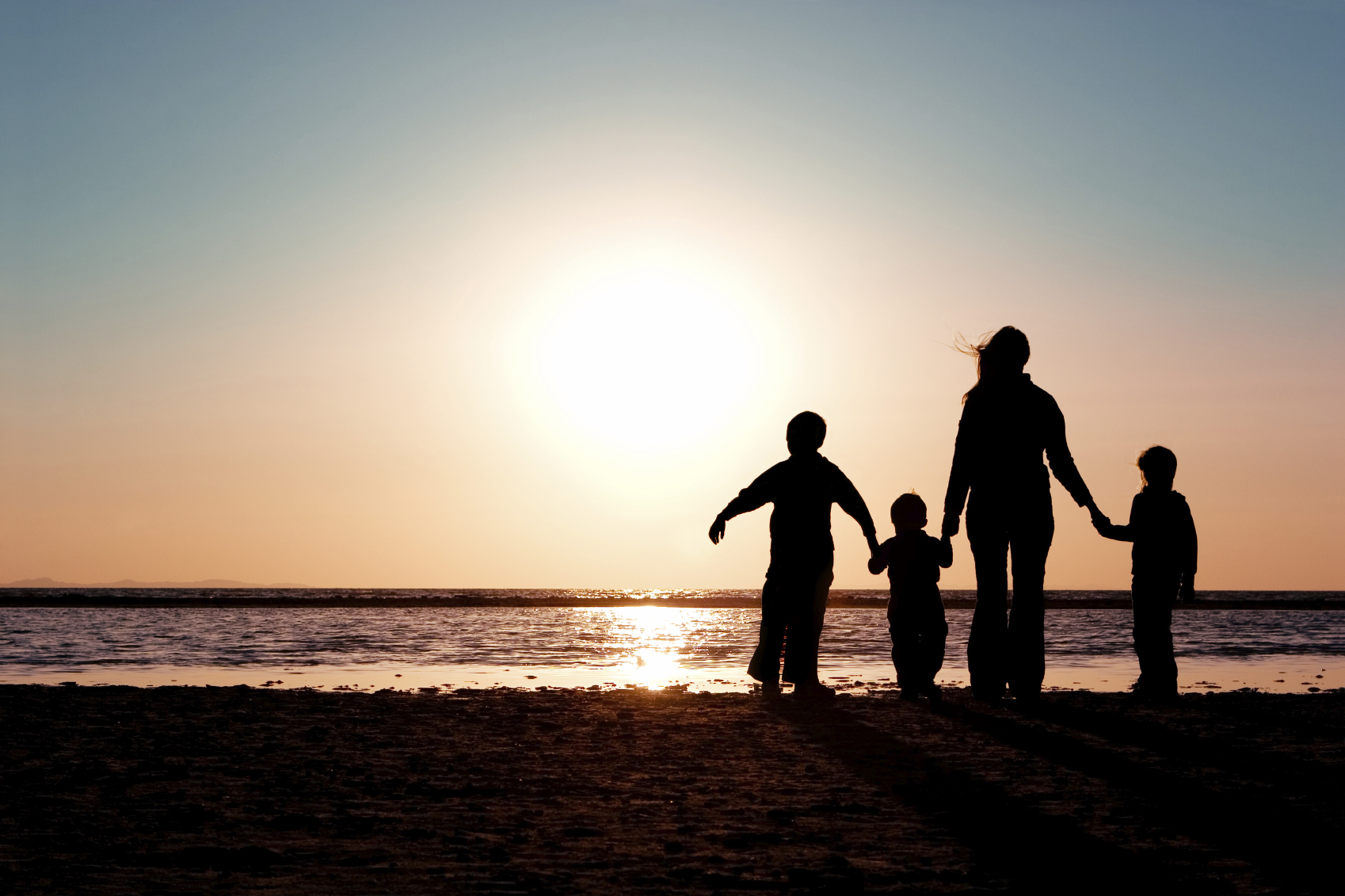 Family silhouette beach